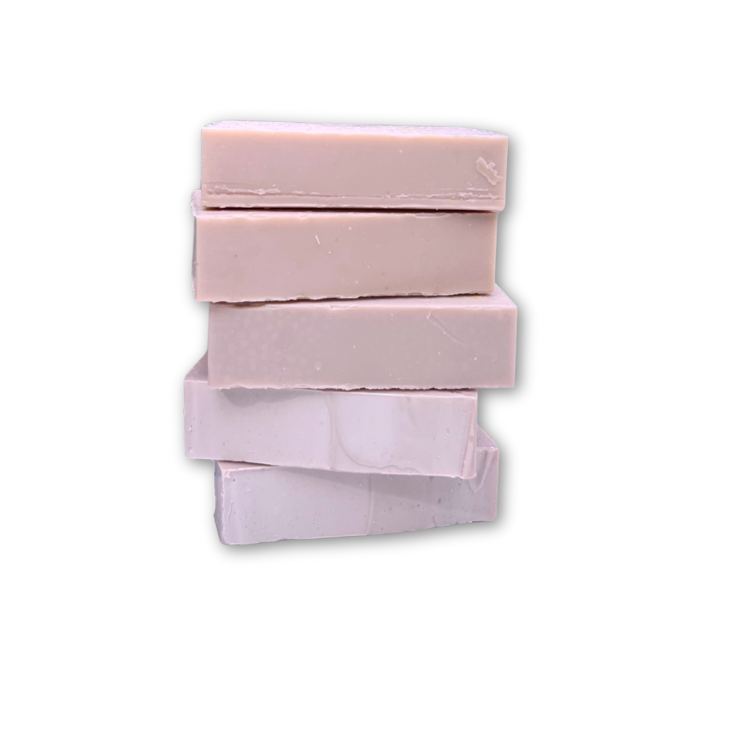 Stack of pink soap bars on a white background