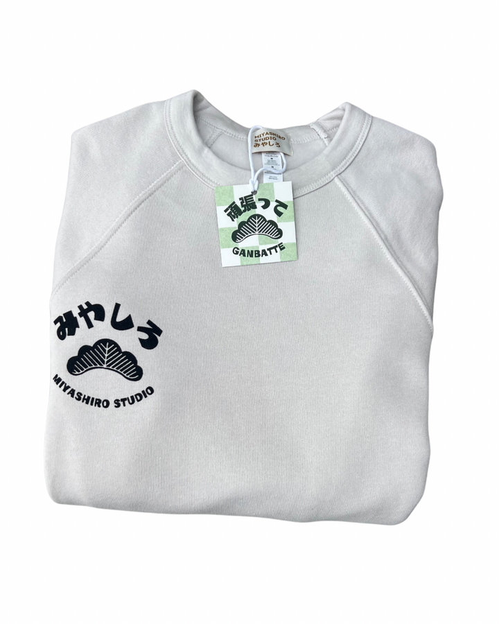 Folded gray sweatshirt with Miyashiro Studio logo and brand tag on a white background