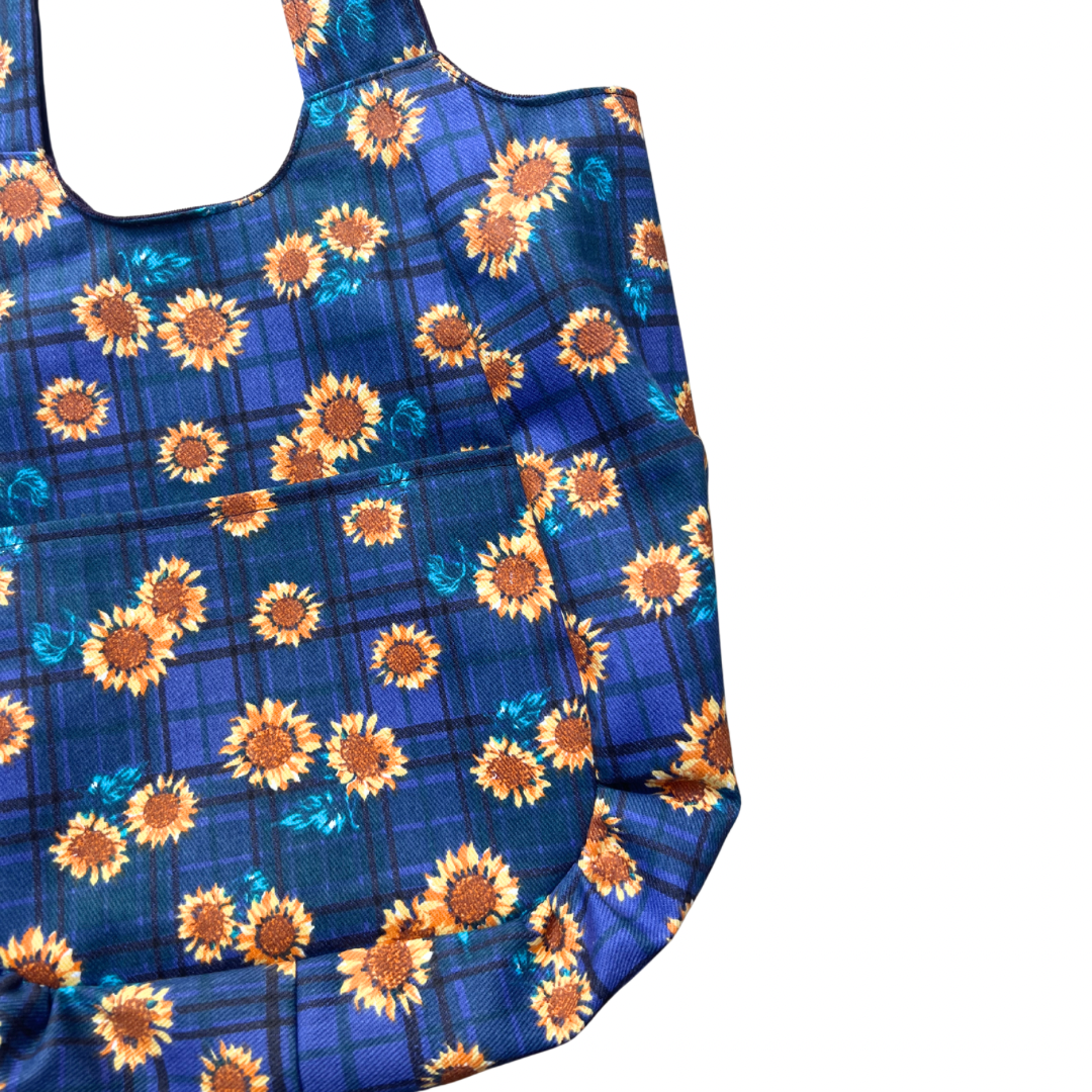 Blue reusable bag with sunflower pattern on a white background