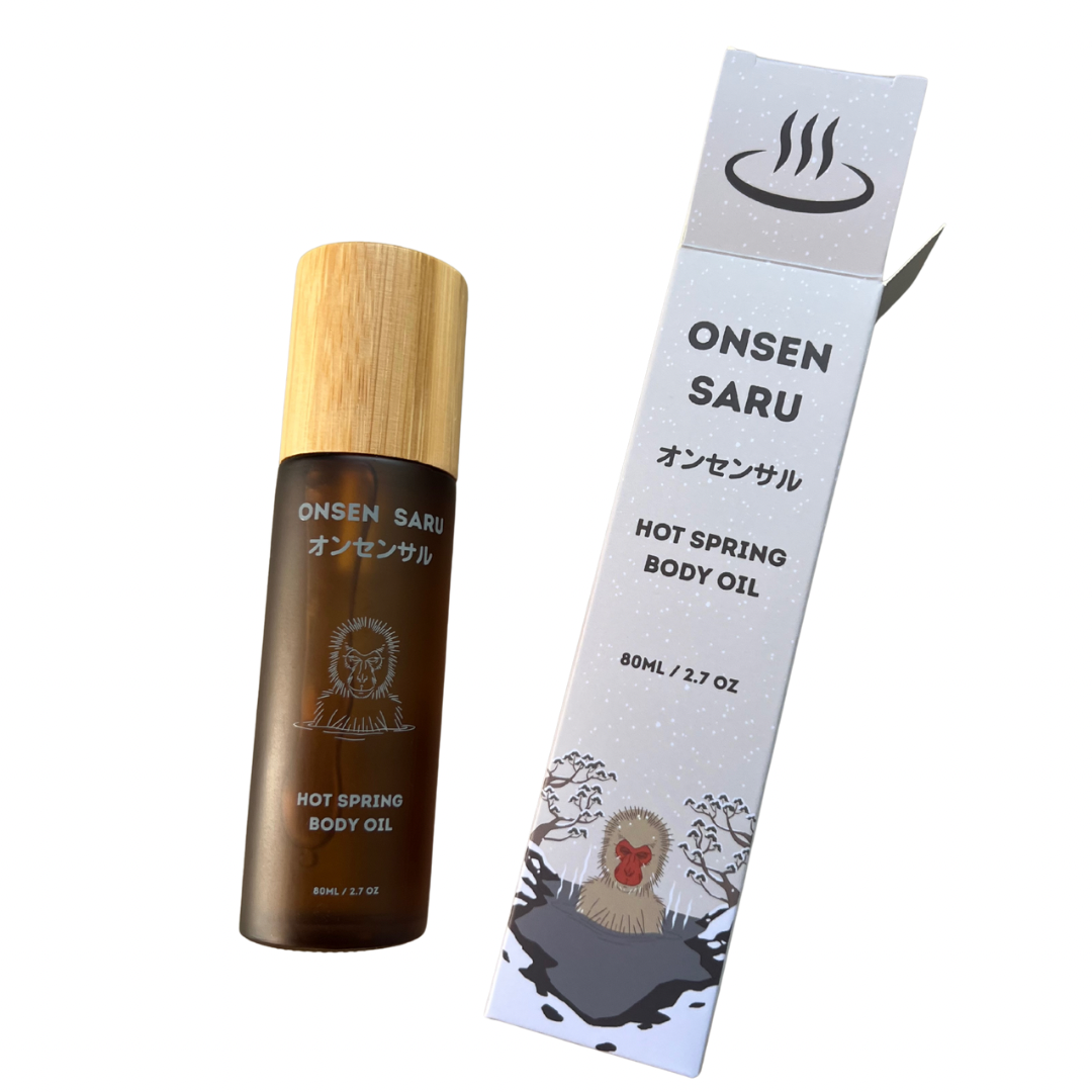 Onsen Saru hot spring body oil bottle and packaging on a white background