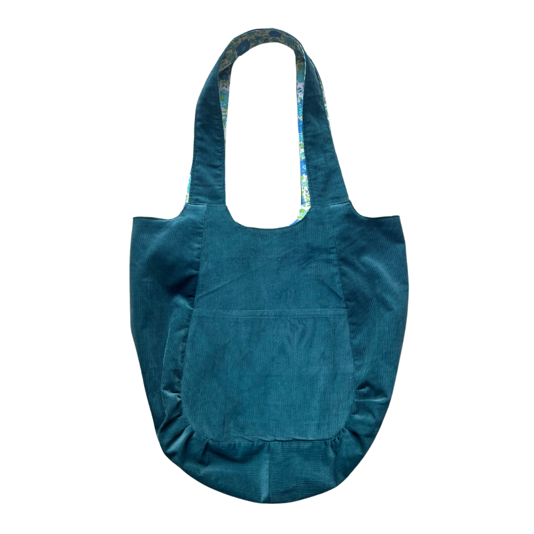 Blue tote bag with a pocket on a white background