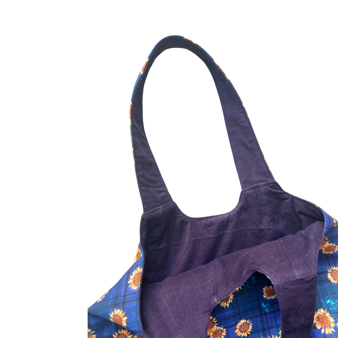 Purple corduroy lining of sunflower print tote bag  on a white background
