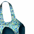 Load image into Gallery viewer, Floral-patterned lining of teal corduroy bag with a white background
