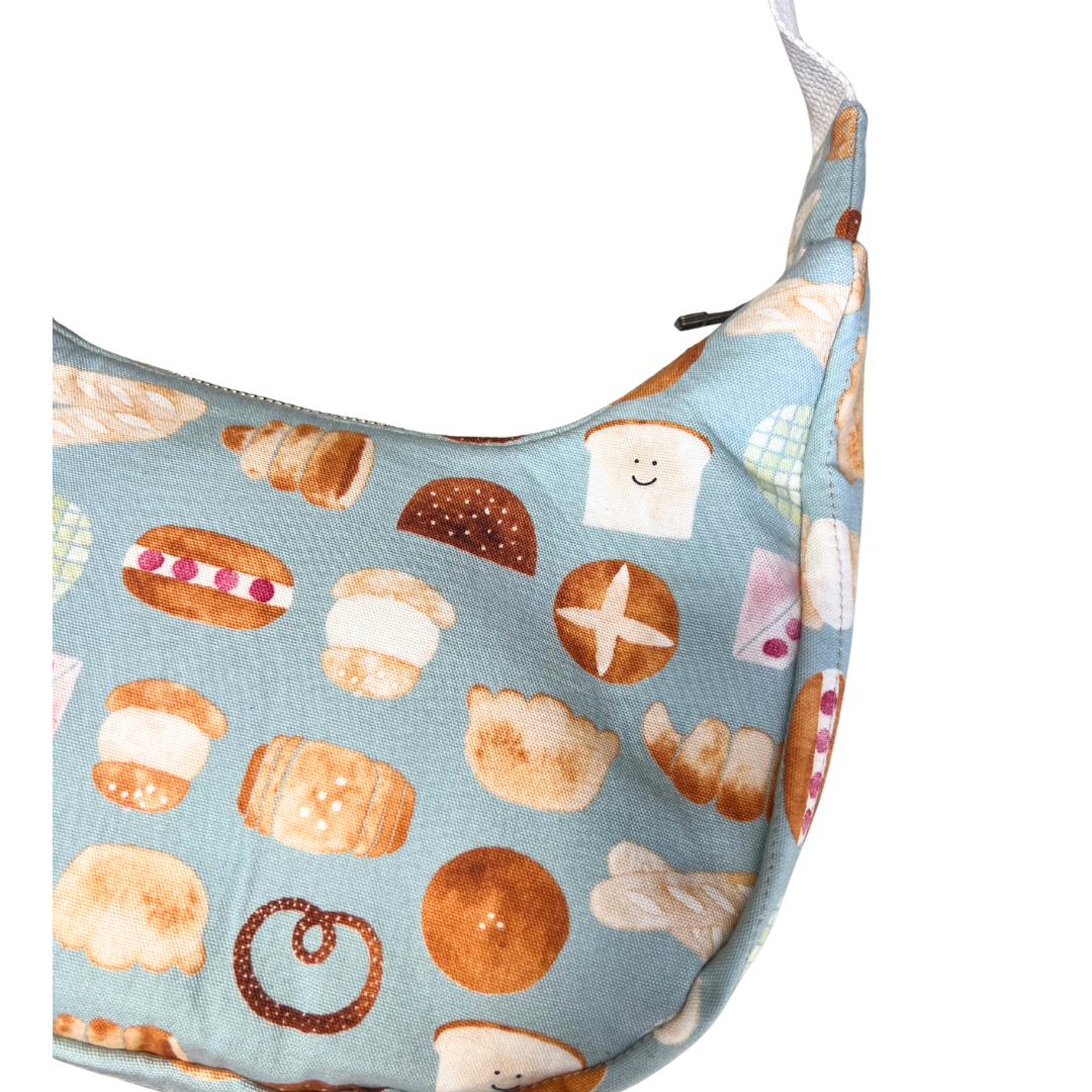 Fabric bag with bread pattern on a light blue background