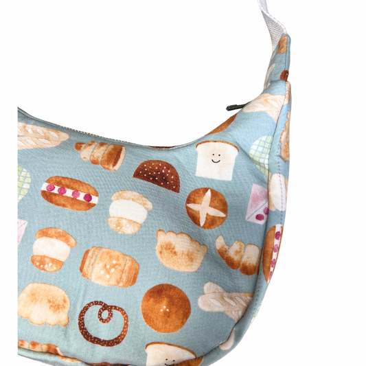 Fabric bag with bread pattern on a light blue background