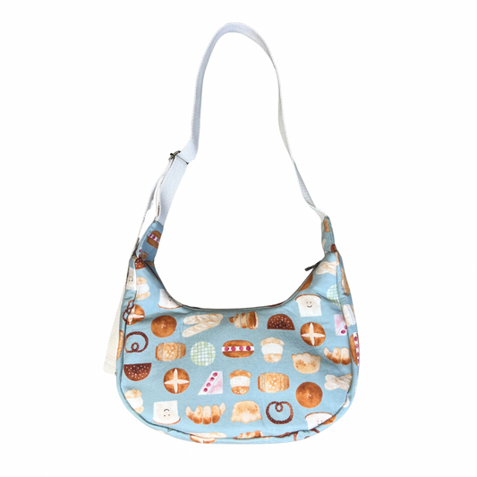 Handbag with a pattern of various pastries on a light blue background
