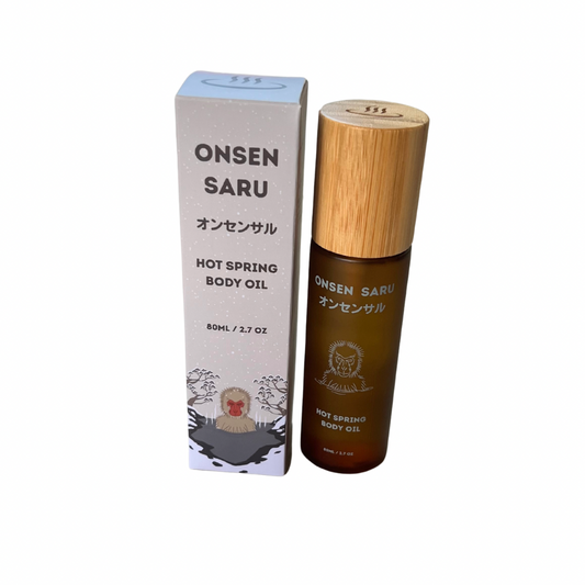 Onsen Saru hot spring body oil with wooden cap and packaging on a white background