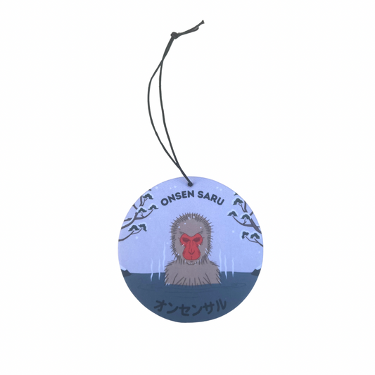 Round air freshener with a monkey design on a white background