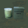 Load image into Gallery viewer, Green candle and packaging with 'SHINRIN-YOKU' text on a green leafy background
